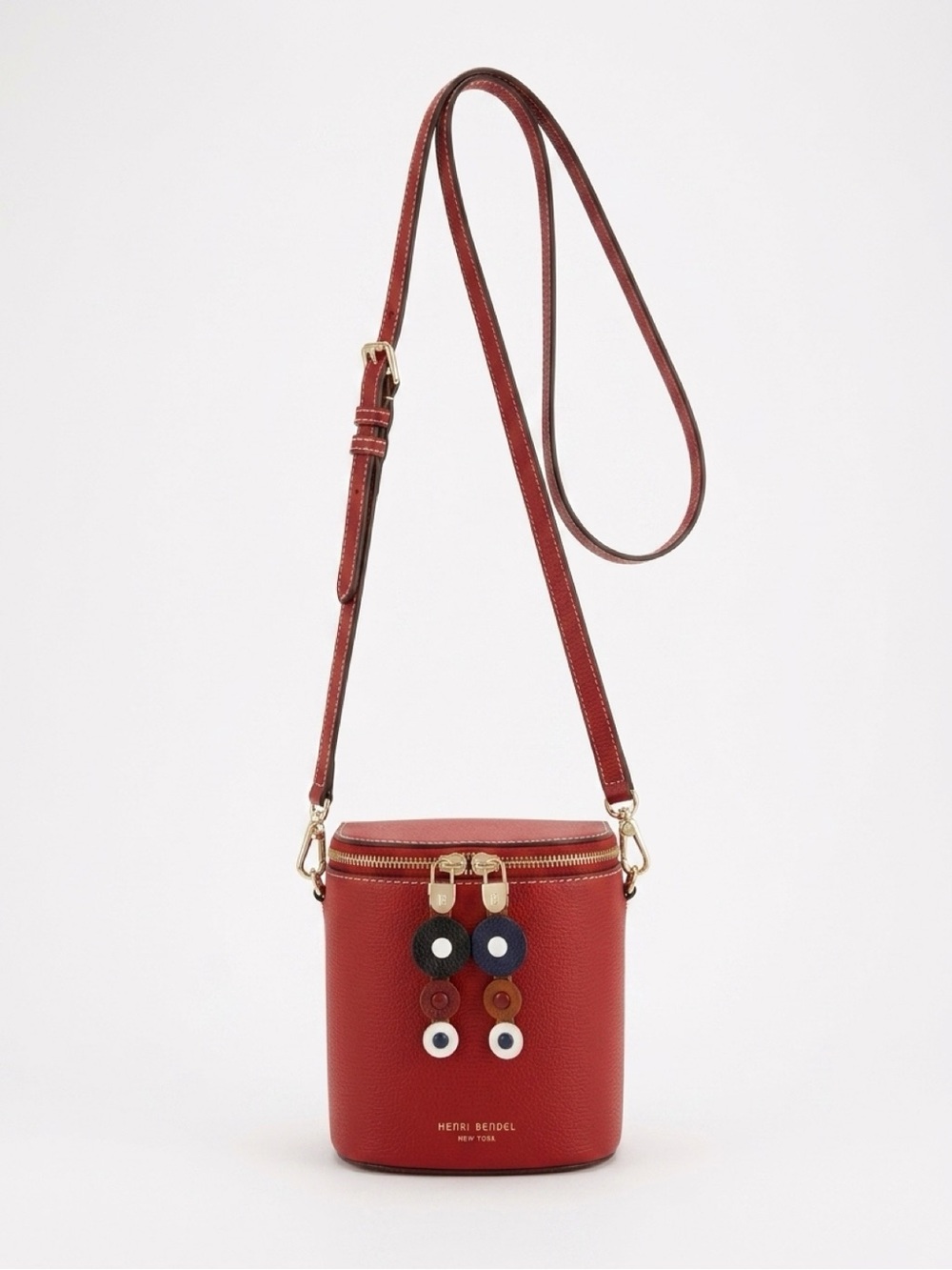 Henri Bendel rust leather crossbody bucket bag with charm accents